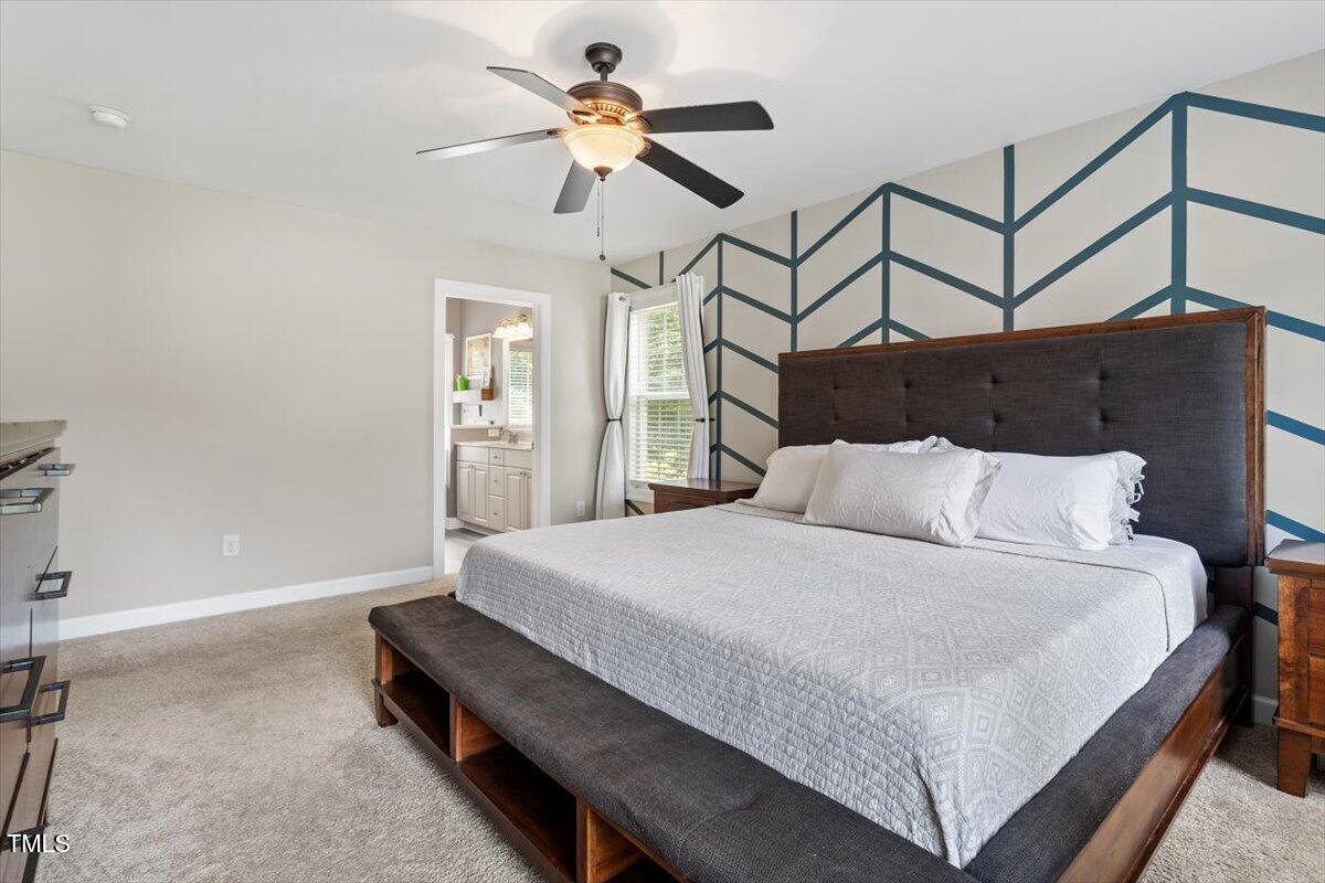 5112 Solemn Grove Road Garner, NC 27529 - Photo 27 of 56 a bedroom with a bed a chandelier and closet