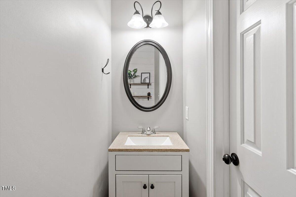 5112 Solemn Grove Road Garner, NC 27529 - Photo 30 of 56 a bathroom with a sink and a mirror