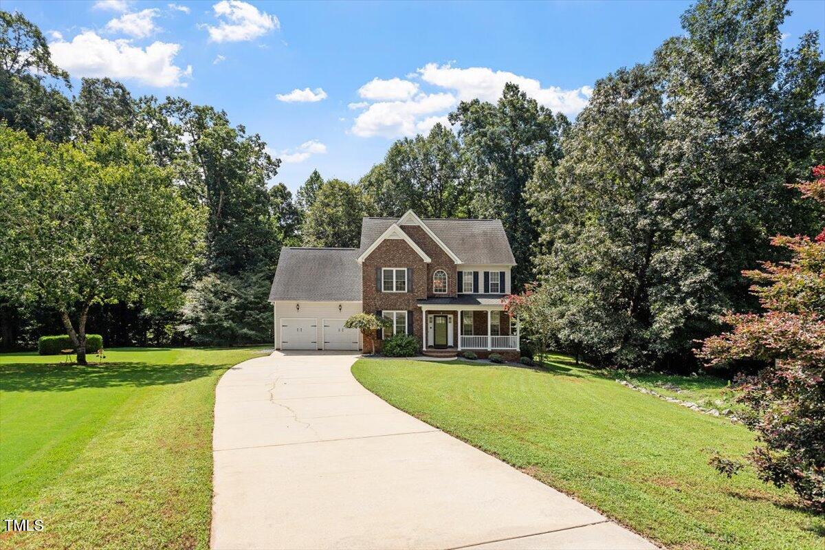 5112 Solemn Grove Road Garner, NC 27529 - Photo 3 of 56 a front view of a house with garden