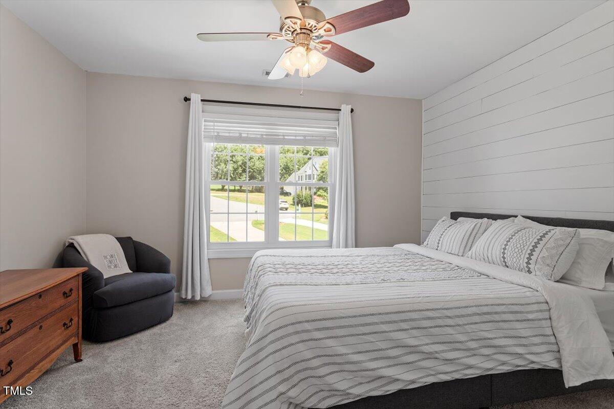 5112 Solemn Grove Road Garner, NC 27529 - Photo 32 of 56 a bedroom with a bed and a couch