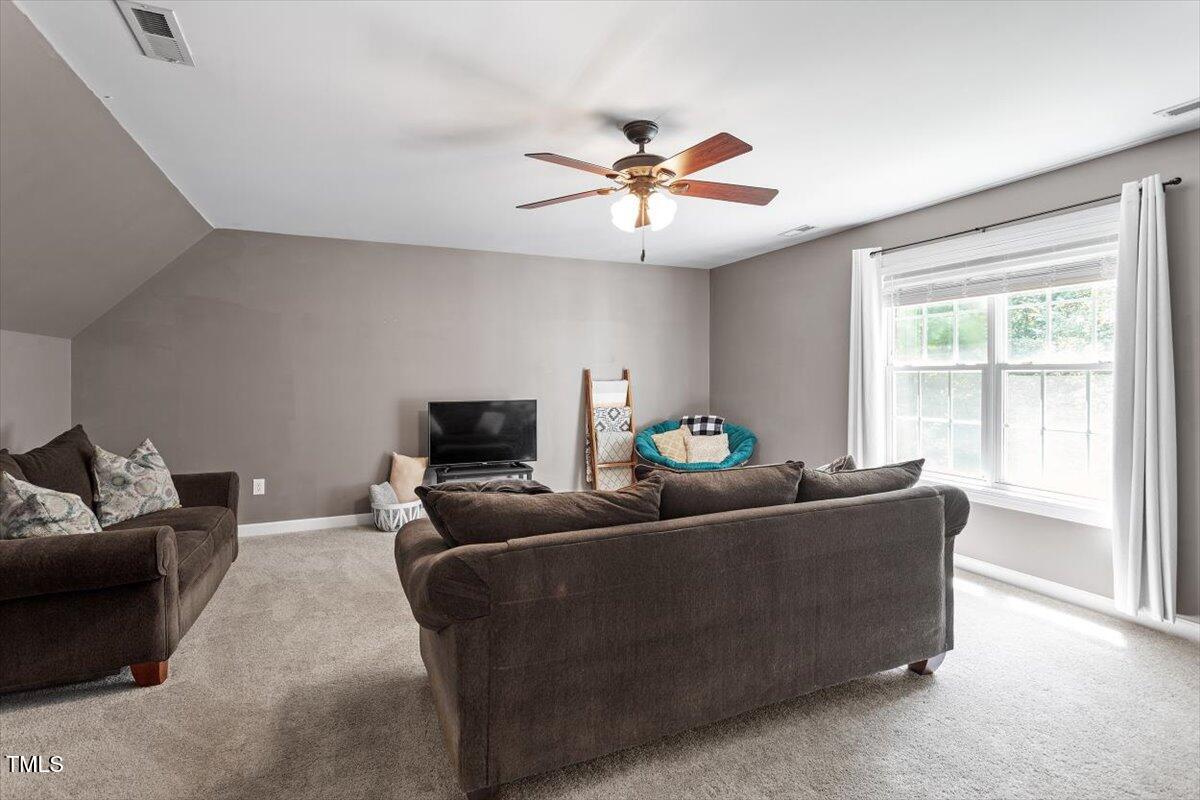 5112 Solemn Grove Road Garner, NC 27529 - Photo 33 of 56 a living room with furniture and a large window