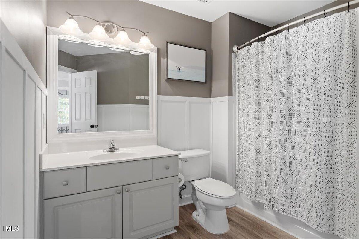 5112 Solemn Grove Road Garner, NC 27529 - Photo 35 of 56 a bathroom with a toilet a sink and a mirror