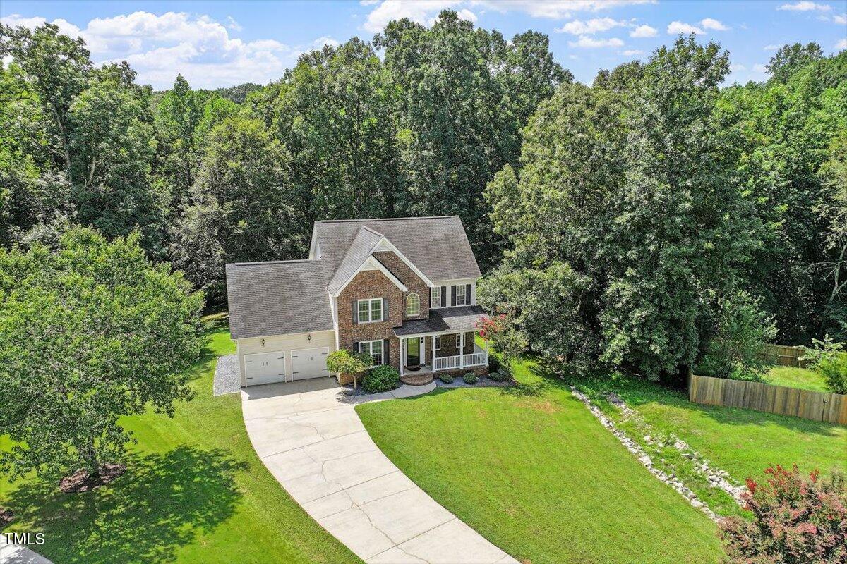 5112 Solemn Grove Road Garner, NC 27529 - Photo 40 of 56 a view of a house with a big yard plants and large trees
