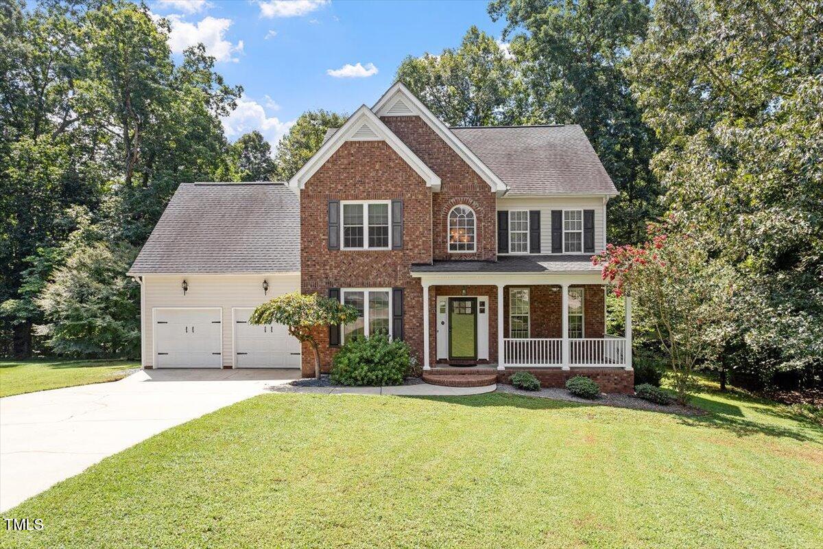 5112 Solemn Grove Road Garner, NC 27529 - Photo 4 of 56 a front view of a house with a yard and garage