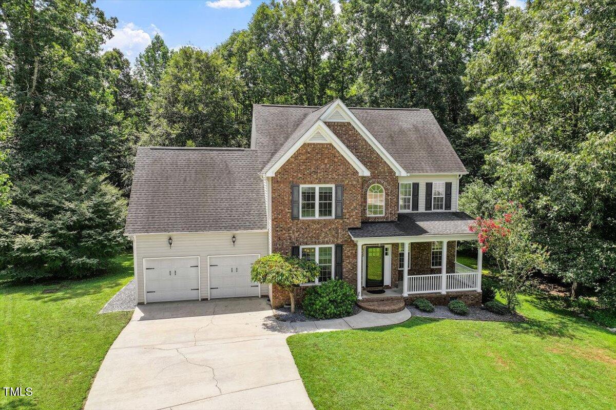 5112 Solemn Grove Road Garner, NC 27529 - Photo 44 of 56 a front view of a house with a yard table and chairs