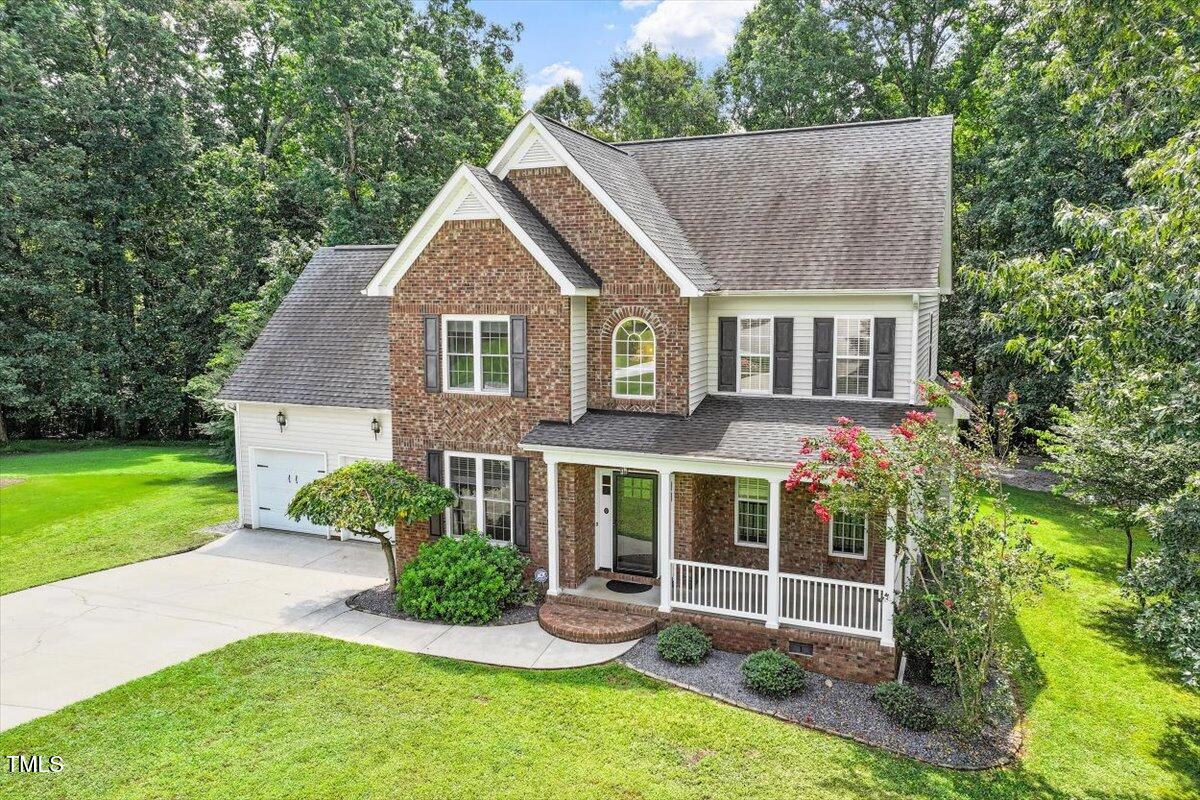 5112 Solemn Grove Road Garner, NC 27529 - Photo 49 of 56 a view of a house with a yard and potted plants