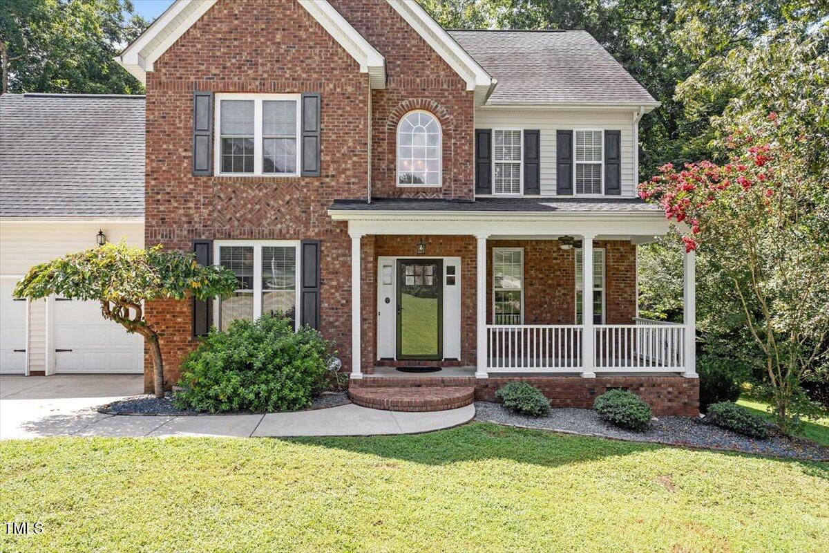 5112 Solemn Grove Road Garner, NC 27529 - Photo 5 of 56 a front view of a house with a yard and porch