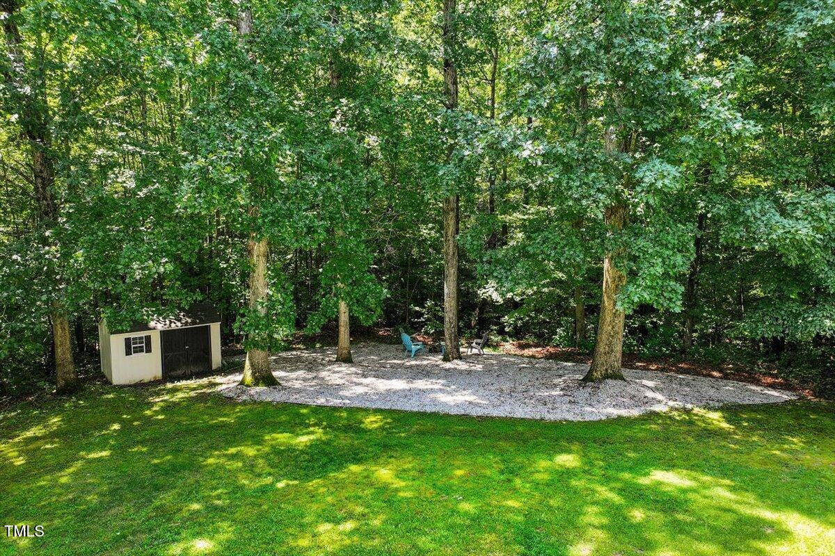 5112 Solemn Grove Road Garner, NC 27529 - Photo 54 of 56 a backyard of a house with table and chairs