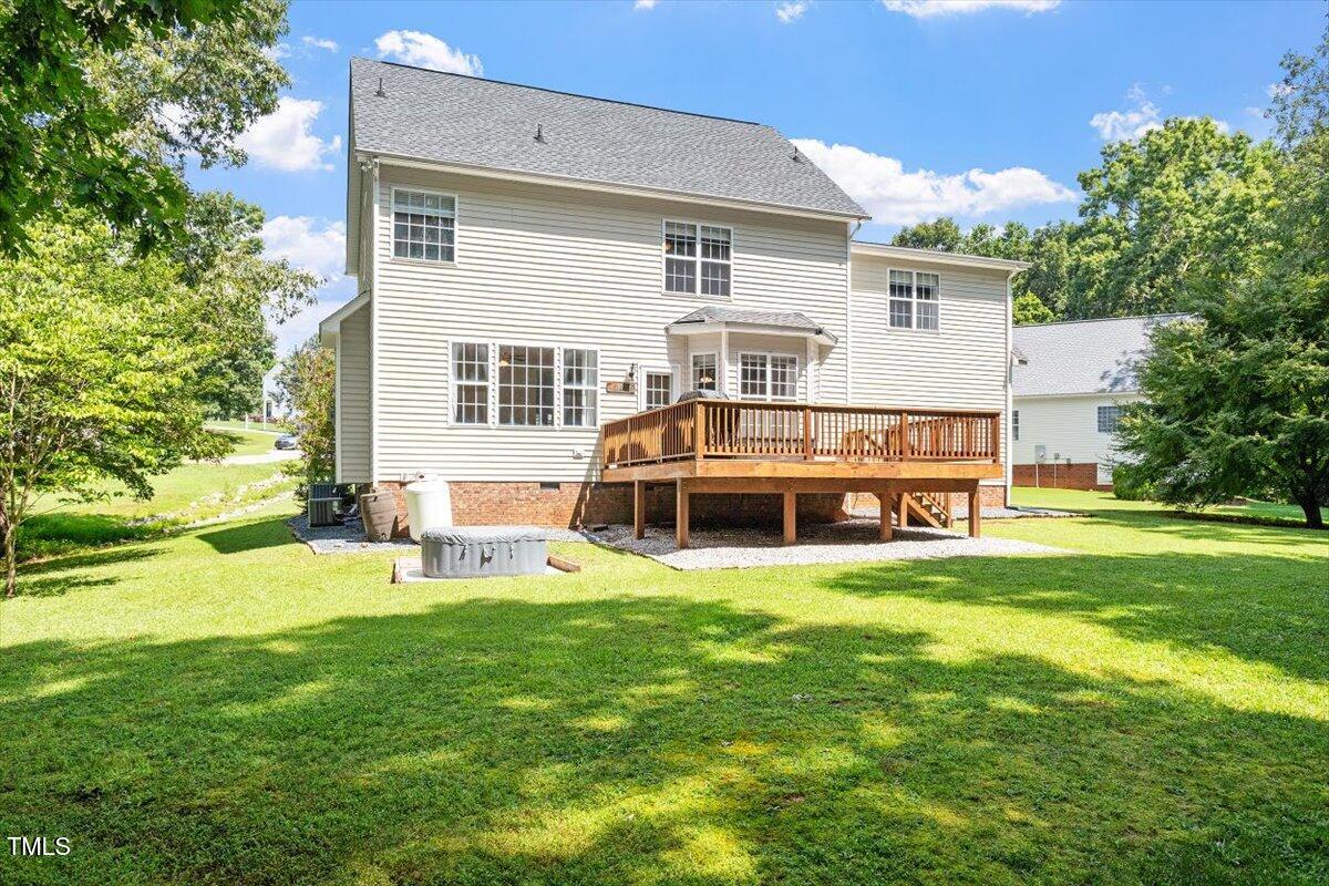 5112 Solemn Grove Road Garner, NC 27529 - Photo 9 of 56 a view of a house with a yard and sitting area