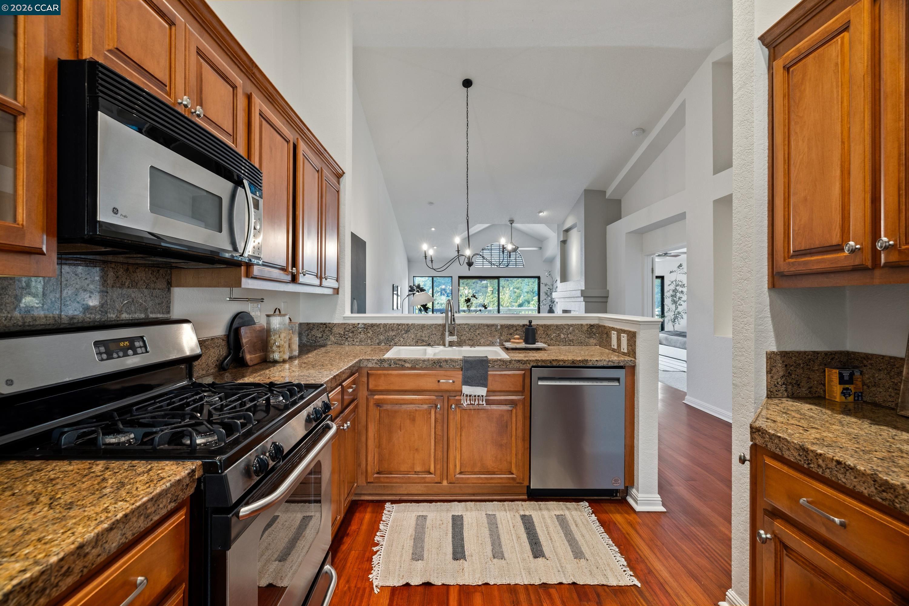 467 Beacon Ridge Lane Walnut Creek, CA 94597 - Photo 19 of 48 a kitchen with stainless steel appliances granite countertop a stove and a microwave