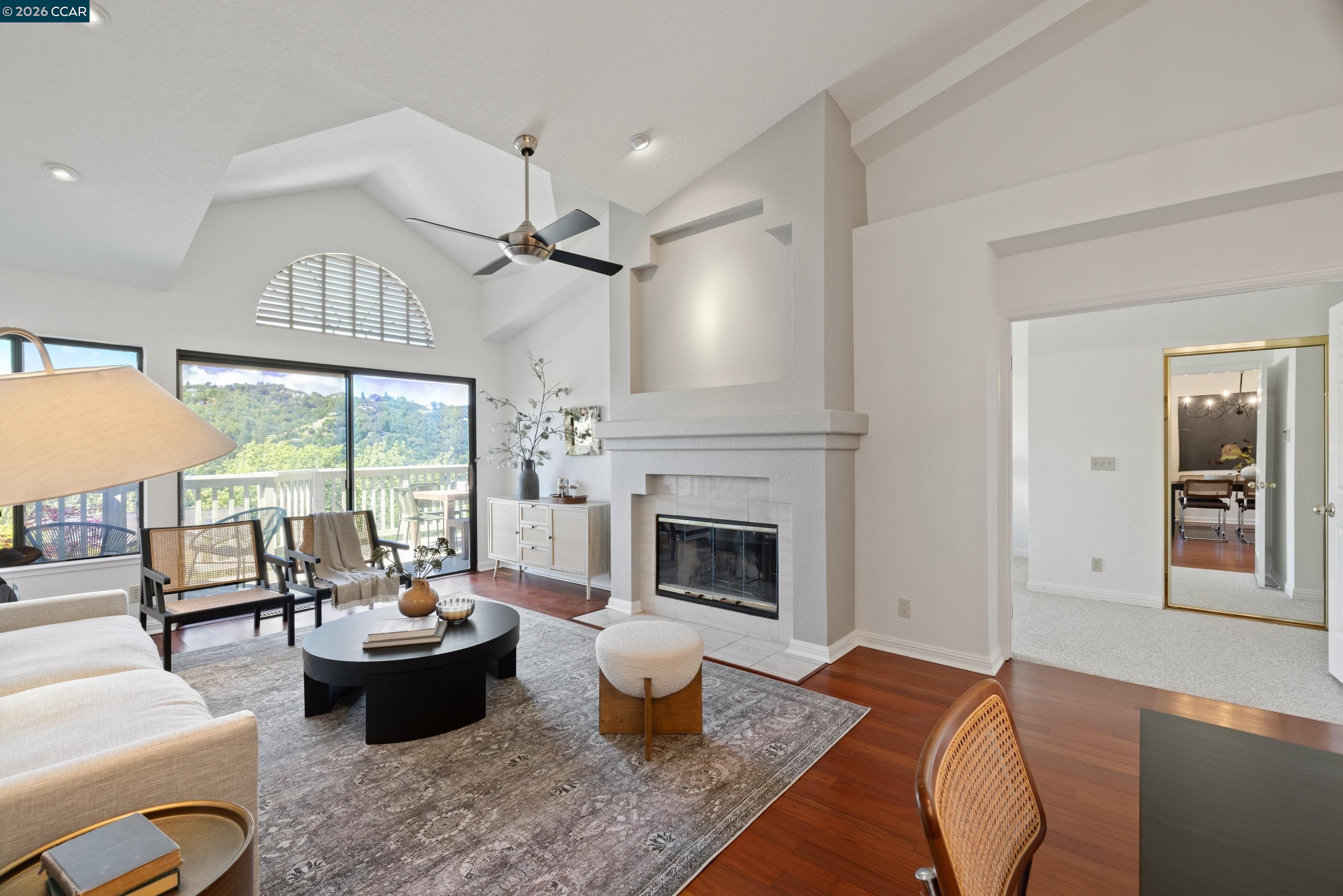 467 Beacon Ridge Lane Walnut Creek, CA 94597 - Photo 10 of 48 a living room with furniture a fireplace and a floor to ceiling window