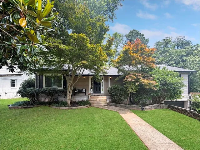 a front view of a house with garden