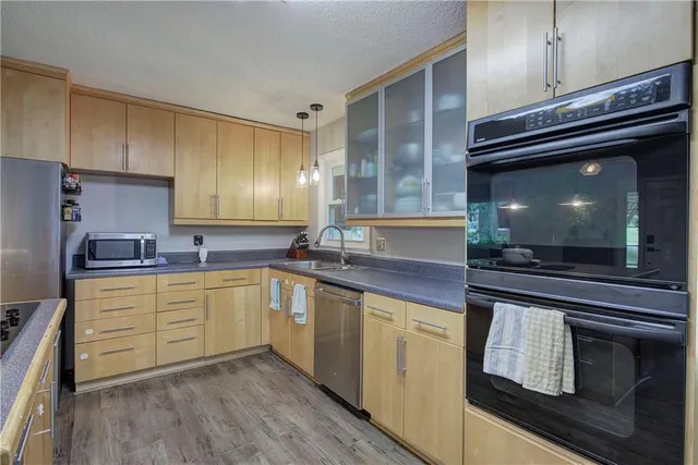 a kitchen with appliances cabinets and a sink