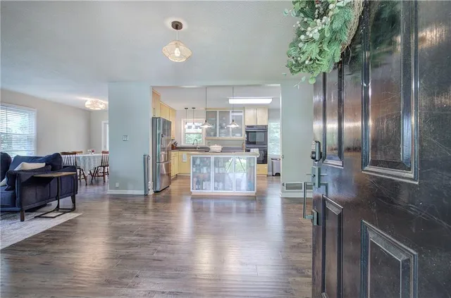 a view of a kitchen with cabinets and wooden floor