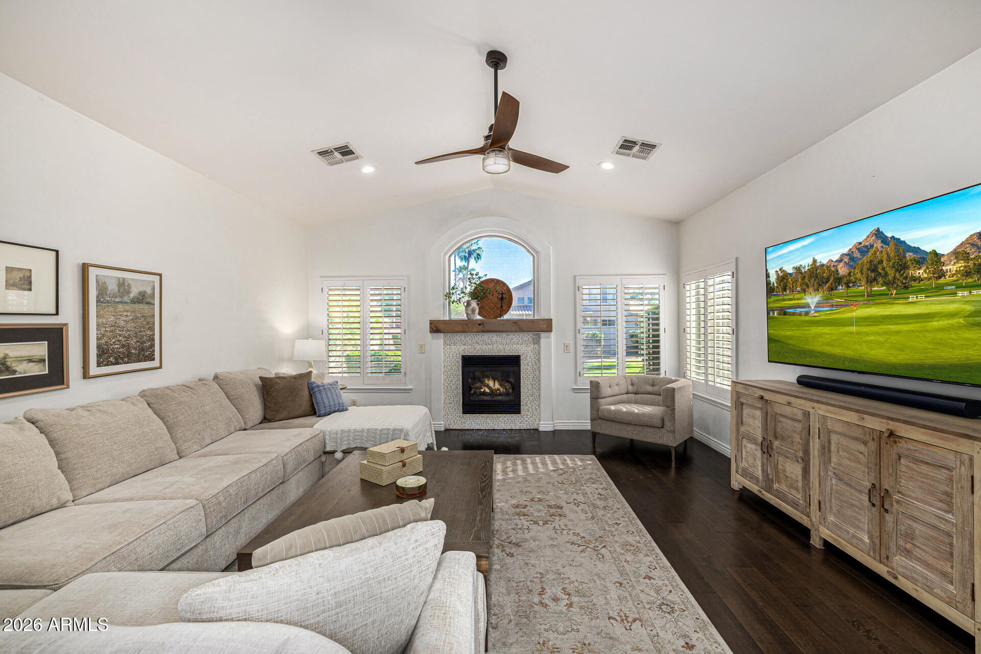 2187 East Finley Street Gilbert, AZ 85296 - Photo 22 of 89 a living room with furniture a fireplace and a flat screen tv