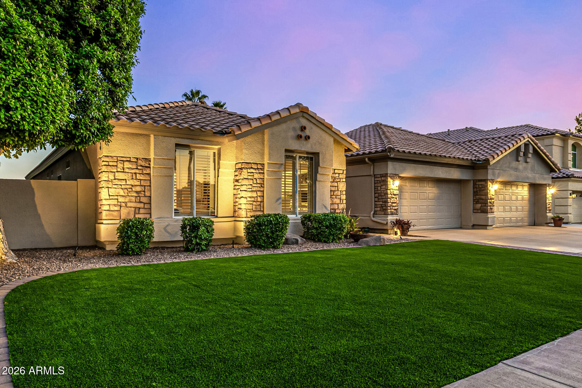2187 East Finley Street Gilbert, AZ 85296 - Photo 3 of 89 a front view of a house with a garden and yard