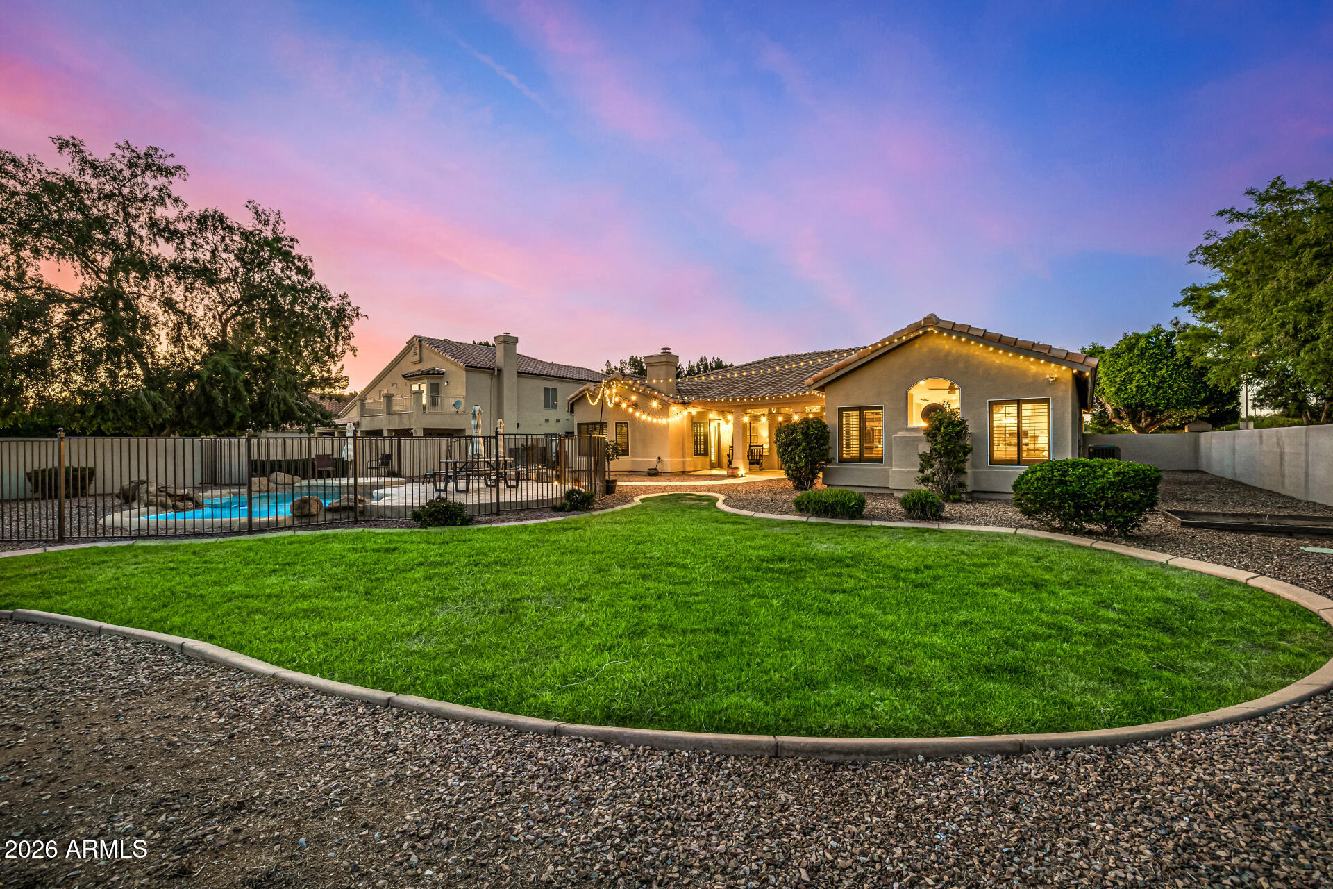 2187 East Finley Street Gilbert, AZ 85296 - Photo 63 of 89 a view of a big house with a big yard couches and wooden fence
