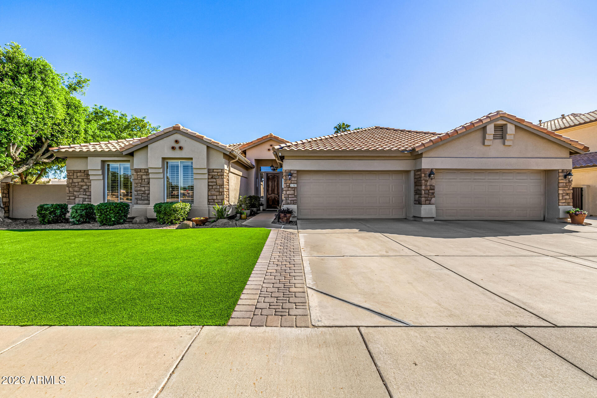 2187 East Finley Street Gilbert, AZ 85296 - Photo 7 of 89 a front view of a house with a garden and plants
