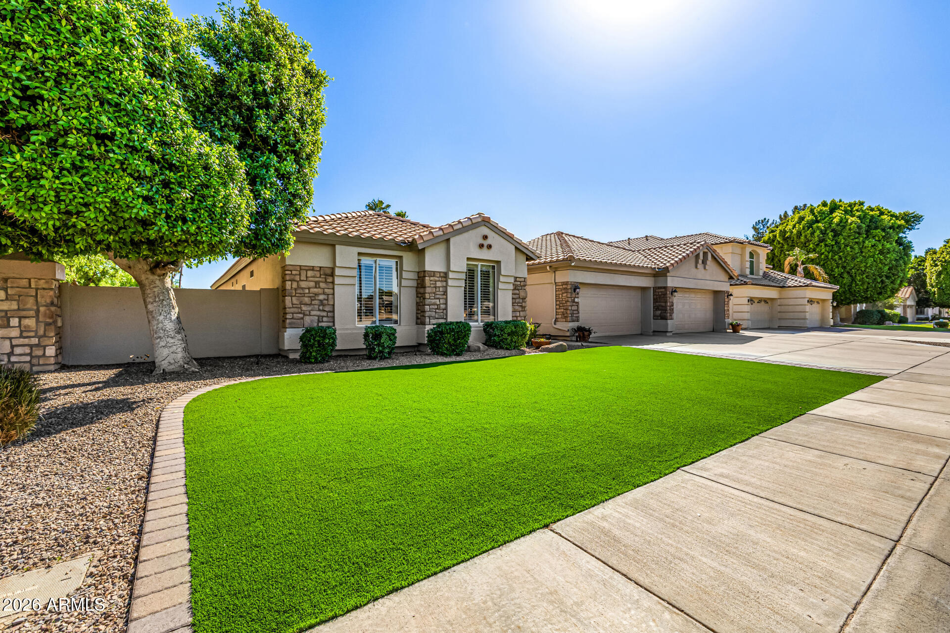 2187 East Finley Street Gilbert, AZ 85296 - Photo 8 of 89 a front view of a house with a garden and yard