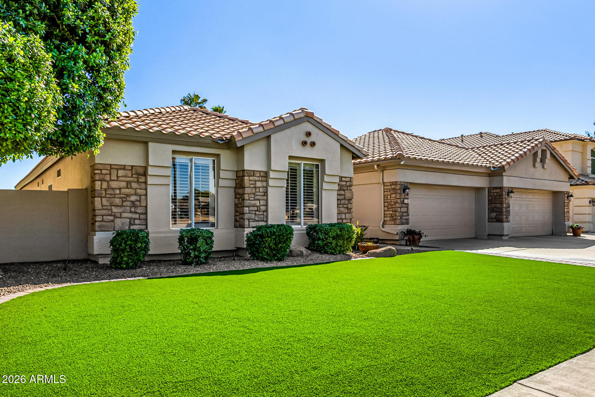 2187 East Finley Street Gilbert, AZ 85296 - Photo 9 of 89 a front view of a house with a garden and yard