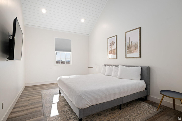 4281 Canterbury Road Hurricane, UT 84737 - Photo 21 of 24 Bedroom featuring wood-finish flooring, a vaulted shiplap ceiling with recessed lighting, and a window with a roller shade