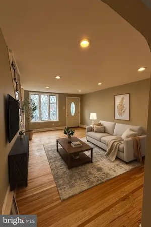 a living room with furniture a flat screen tv and a window