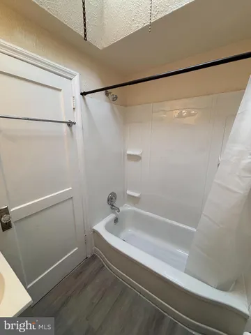 a bathroom with a shower and a bath tub