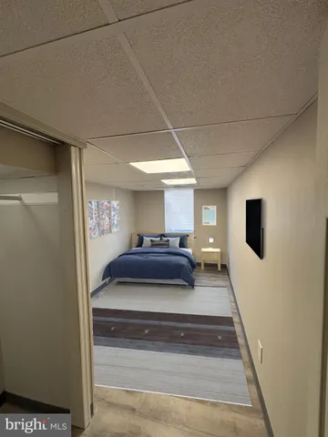 a spacious bedroom with a bed and a flat screen tv