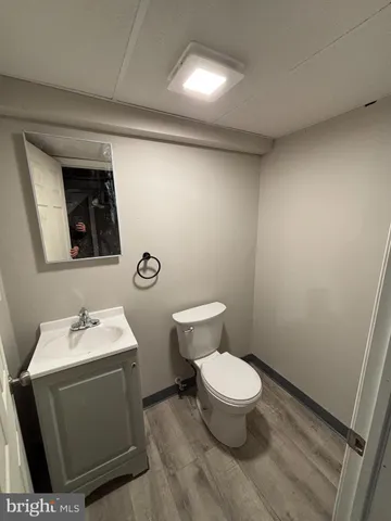 a bathroom with a toilet sink and mirror
