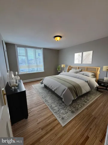 a bedroom with a bed window and couch