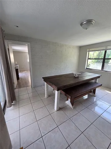 a room with pool table and window
