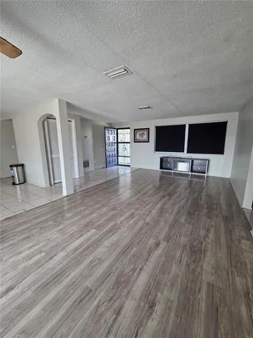 a view of a livingroom with wooden floor and a cabinet