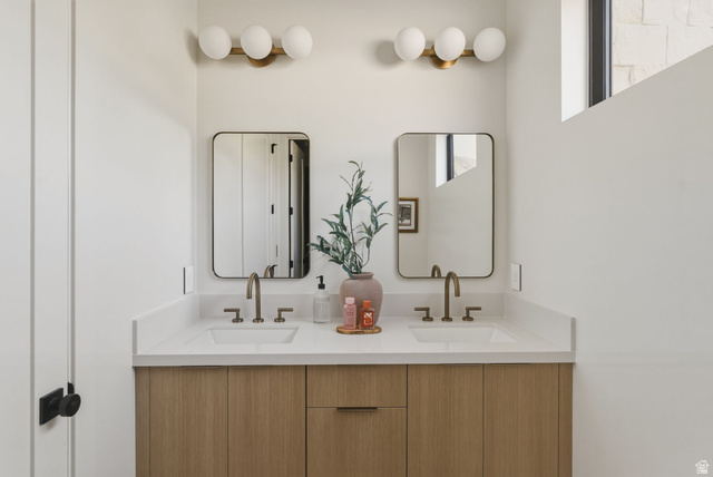 923 North Emery Lane Elk Ridge, UT 84651 - Photo 41 of 101 Dual vanity with wood-finish cabinetry, white countertops, and matte gold-tone fixtures