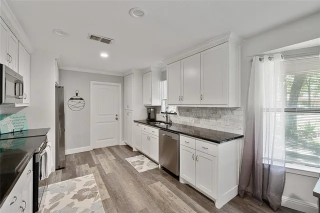 a kitchen with a sink stove and refrigerator