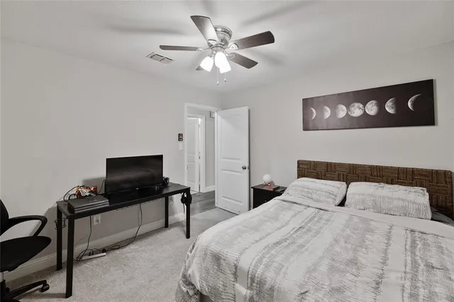 a bedroom with a bed and dresser