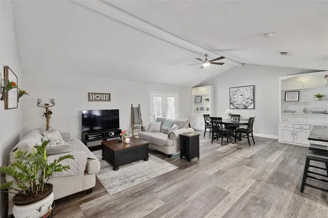 a living room with furniture a rug and a flat screen tv