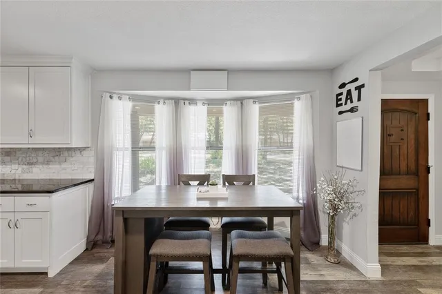 a dining room with a large window table and chairs