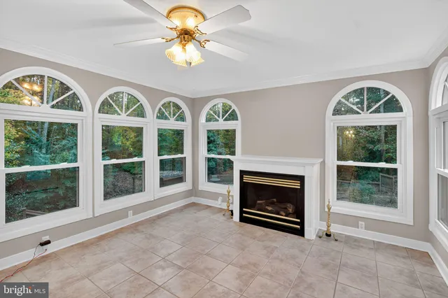 a view of an empty room with a fireplace and a window