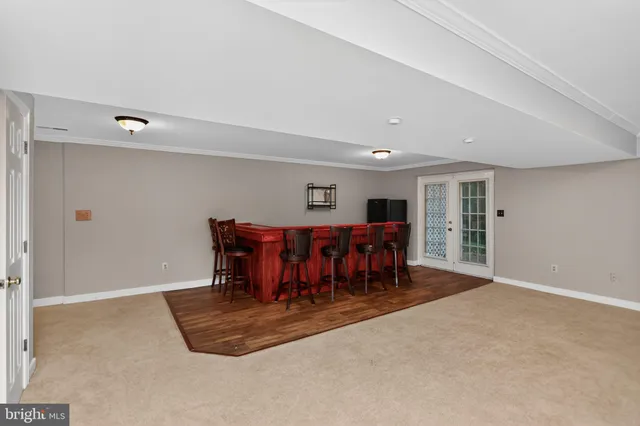 a dining room with furniture and a chandelier