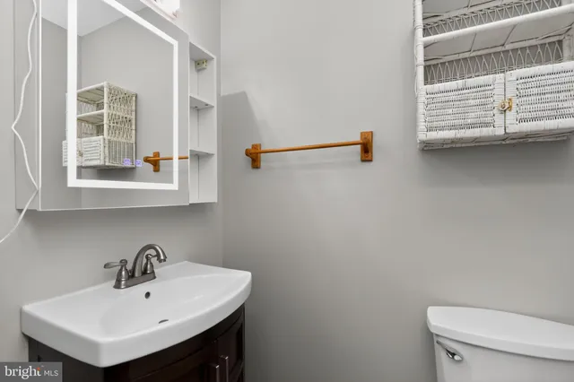 a bathroom with a sink a mirror and a toilet