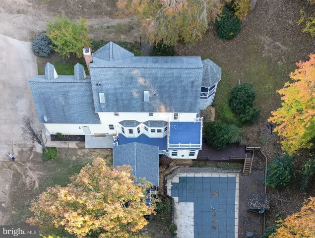 an aerial view of a house with garden space and street view