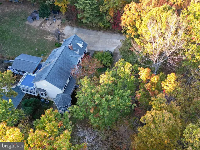 an aerial view of house with yard swimming pool and outdoor seating