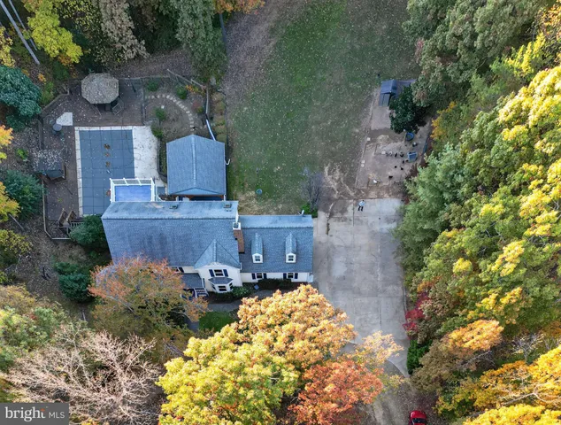 an aerial view of a house with yard swimming pool and outdoor seating