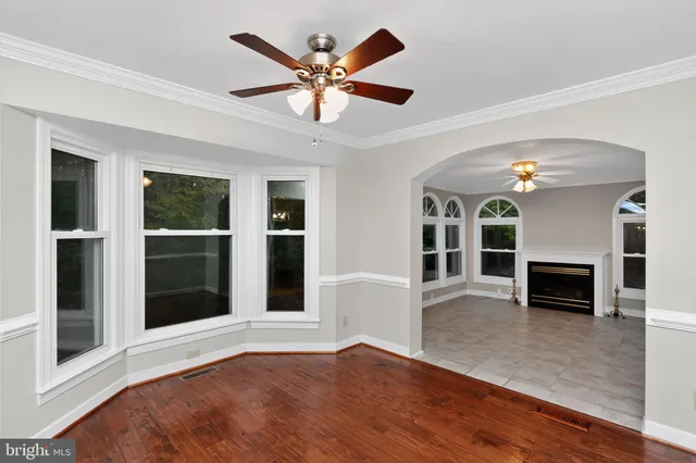 a view of an empty room with a fireplace and a window