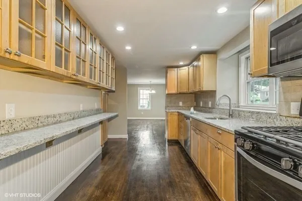 a kitchen with stainless steel appliances granite countertop a stove and a sink
