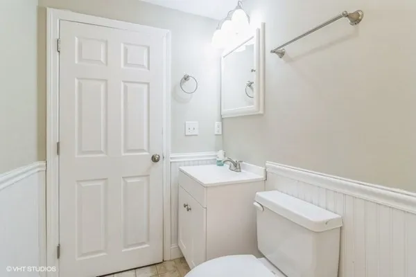 a bathroom with a sink a toilet and a mirror