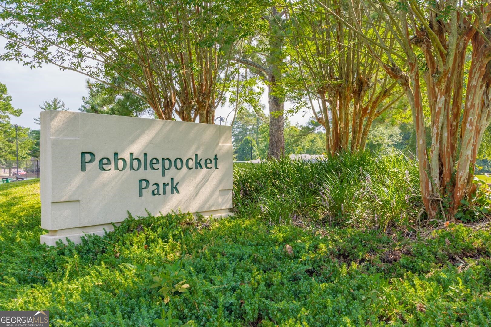 200 Willow Road, Unit 2C Peachtree City, GA 30269 - Photo 11 of 14 a sign that is sitting in front of a tree