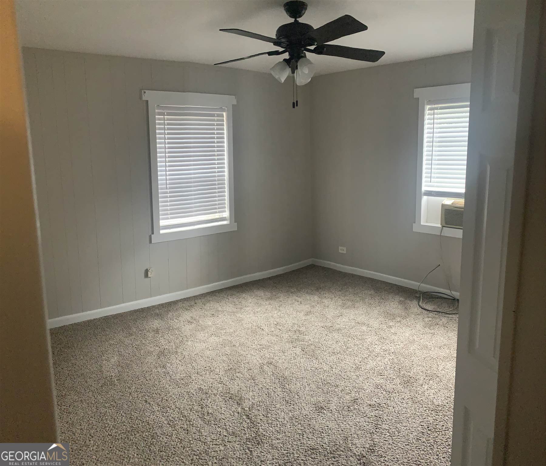 200 Willow Road, Unit 2C Peachtree City, GA 30269 - Photo 5 of 14 an empty room with a window and a fan