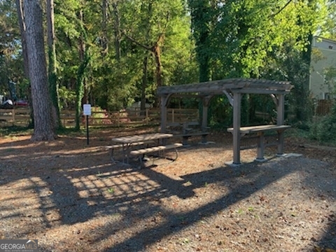 200 Willow Road, Unit 2C Peachtree City, GA 30269 - Photo 9 of 14 a view of a backyard with wooden fence and a large tree