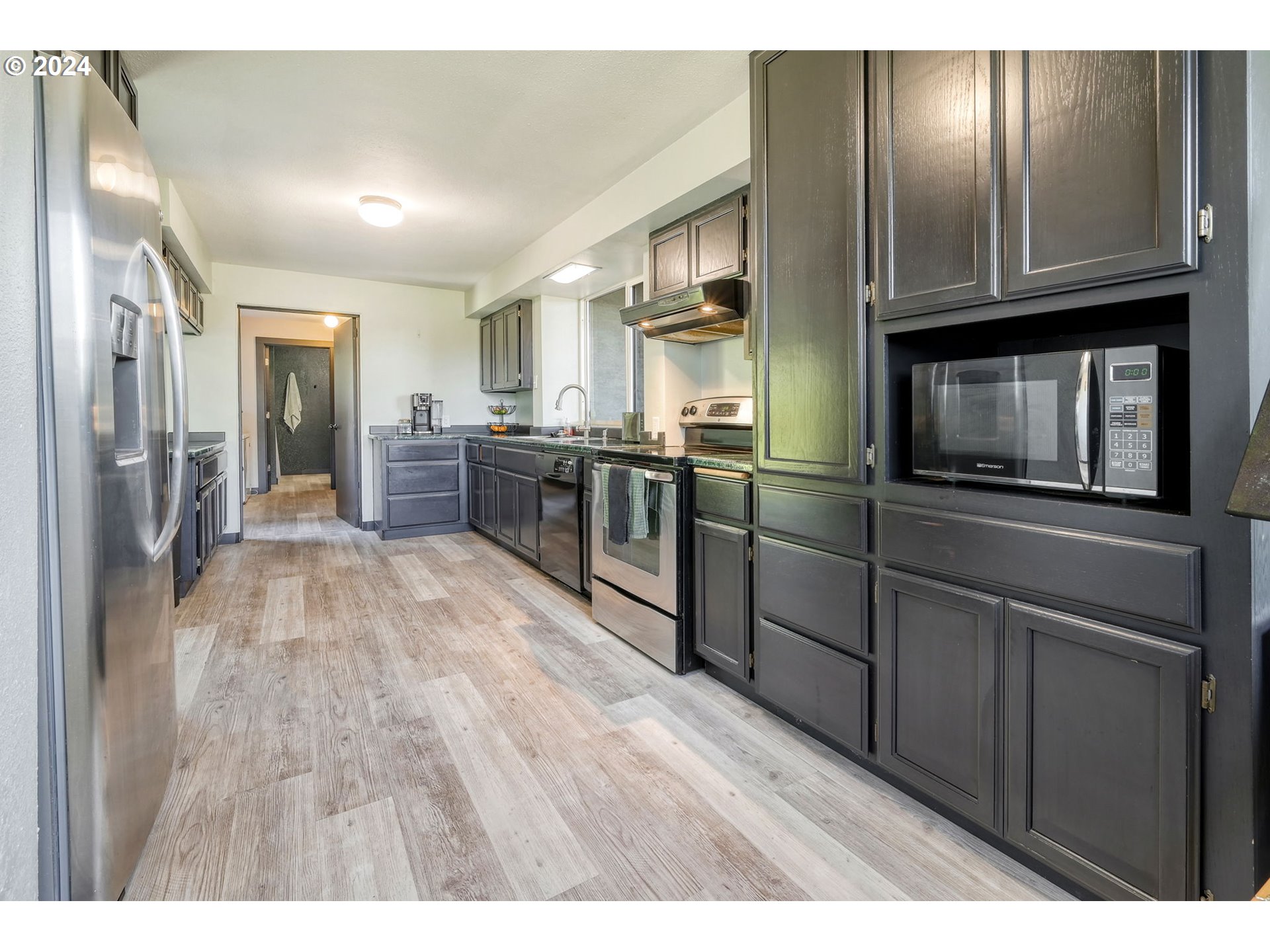 5422 Mt Vernon Road Springfield, OR 97478 - Photo 15 of 44 a kitchen with granite countertop stainless steel appliances and wooden cabinets